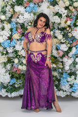 Portrait of a young attractive brunette woman in oriental dance costume