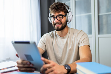 Fototapeta premium Student with Glasses Studying on Tablet