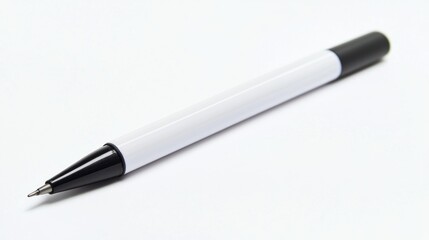 A white and black pen with a black cap, lying on a white surface with a shadow cast on it.
