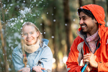 Couple Sitting in Snowy Forest – Man and Woman Engaged in Serious Conversation While Trekking in...