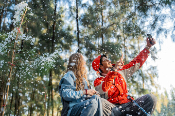 Couple Sitting in Snowy Forest – Man and Woman Engaged in Serious Conversation While Trekking in...