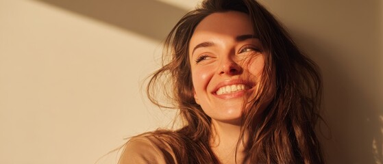 The smiling woman bathed in warm sunlight with natural joyful carefree expression