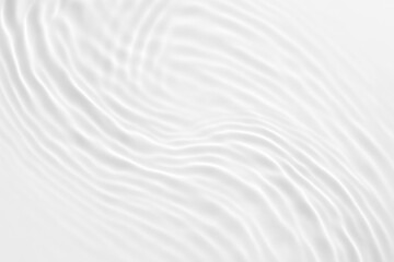 Obraz premium Abstract white ripples and waves on a clean surface creating a gentle flowing texture