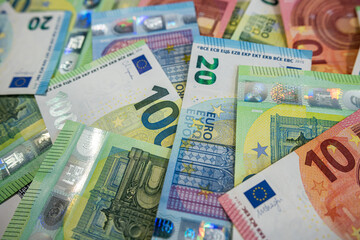 Scattered Euro banknotes in various denominations symbolizing wealth, cash flow and investment