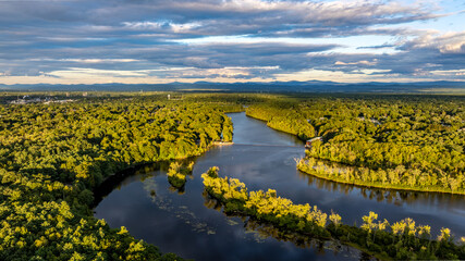 Queensbury, NY, USA - August 27, 2025: Late afternoon aerial view over the Queensbury, NY, and the Hudson River, near the southern boundary of the Adirondack Park of of Interstate 87.	