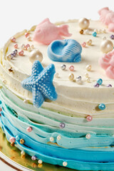 Delicious ocean-themed cake decorated with fondant sea creatures and pearls