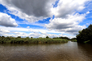 Pilica River between the bridges clouds over the river