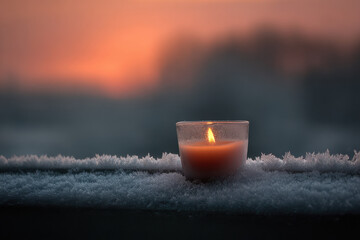frostcovered window adorned with intricate icy patterns showcases solitary warm candle flickering inside
