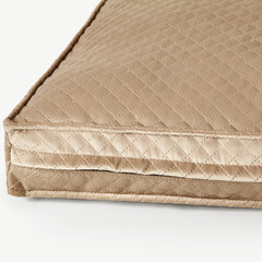 Naklejka premium Beige velvet cushion showing quilted pattern and seam