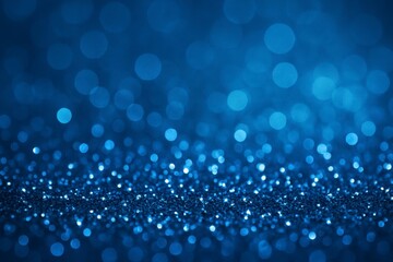 Abstract deep blue bokeh background with sparkling glitter particles creating a magical and festive atmosphere