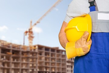 Safety workwear hold safety helmet at construction