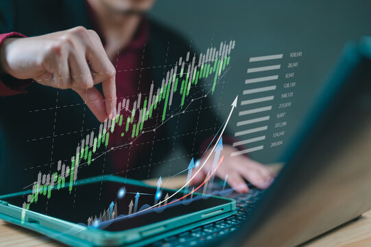 Businessman analyzing financial stock market data with digital tablet and laptop, showing growth charts, rising graphs, investment strategy, and technology for trading success.