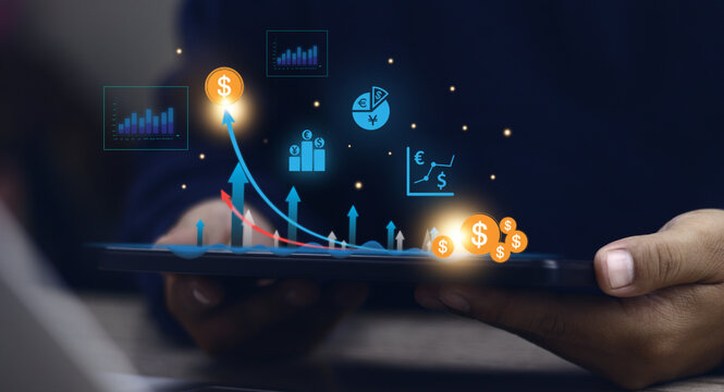 "Digital business growth with data analysis and investment. A professional's hand holds a tablet, showing financial charts, dollar signs, and currency symbols. AI-powered financial technology."