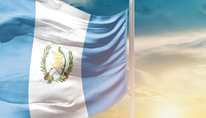 Guatemala national flag waving in an amazing sunlight. National flag wavering on mast.