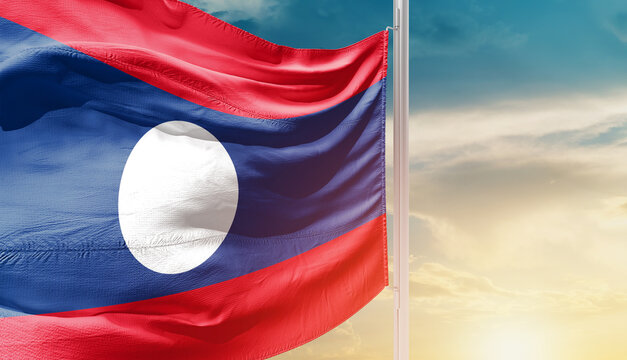 Laos national flag waving in an amazing sunlight. National flag wavering on mast.