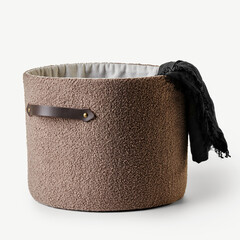 Laundry basket with black scarf hanging out on white background