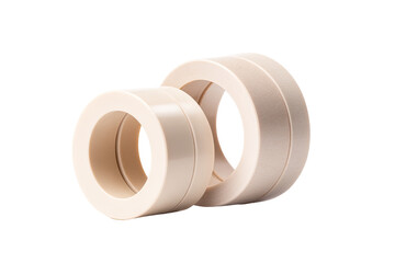 Two beige plastic bushings on white background