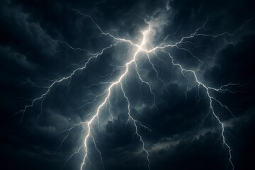 Dramatic bright white lightning bolt illuminating dark stormy clouds during a powerful thunderstorm at night