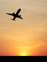 Soaring to New Heights: A silhouette of an airplane ascends gracefully against the backdrop of a vibrant sunset, creating a sense of wonder and boundless possibilities.