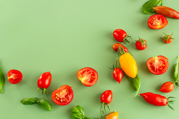 Minimal flat lay of ripe tomatoes and basil leaves