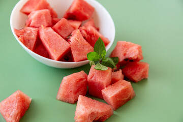 bright watermelon slices in bowl and on surface