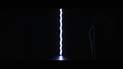 Central vertical band of bright textured light is presented against darkness minimal and dramatic - Powered by Adobe