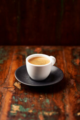 Cup of coffee on rustic wooden background. Soft focus. Copy space	