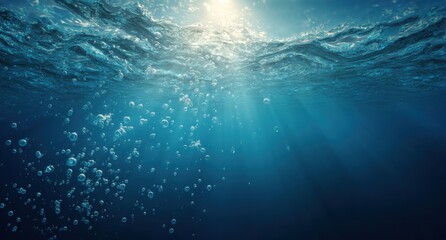 Underwater sunlight beams through rippling water