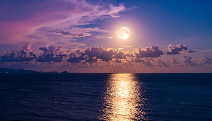 Full moon over a tranquil ocean at twilight
