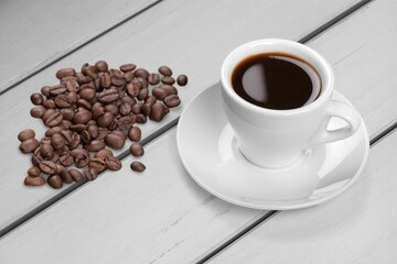 Coffee cup and beans on  desk background