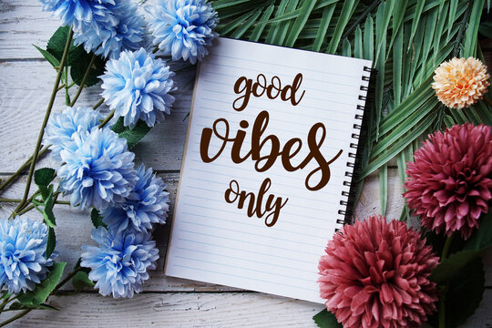 Good vibes only text message with flowers decoration on wooden background - Powered by Adobe