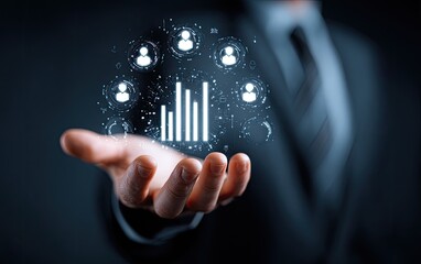 Businessman's hand holding a holographic projection of a bar graph and people icons