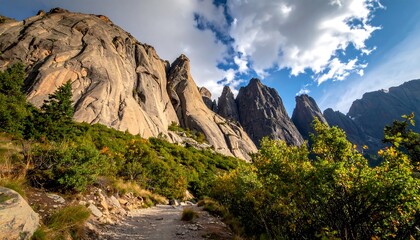 Dramatic mountain landscape showcasing towering rock formations and a lush valley.