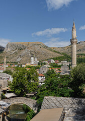 tiny small crooked bridge medieval old roman in old town of mostar herzegovina with nature around