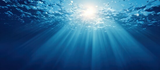 Fototapeta premium Sunlight beams through deep blue water (1)