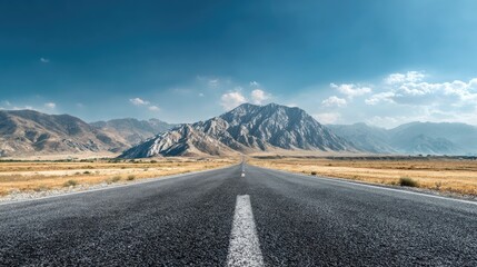 Naklejka premium Straight road disappearing into the distance, mountain landscape