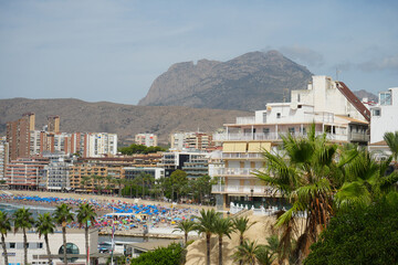 Benidorm, Spain &ndash; September 6 2025: Stunning view of summer beachfront with high rise hotels and mountain scenery