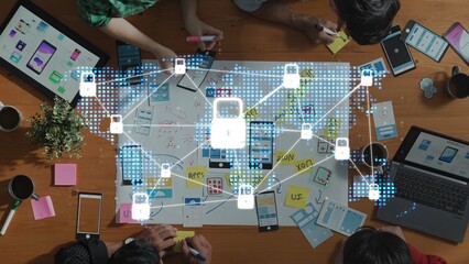 A dynamic collaborative workspace featuring professionals engaged in digital security ideation, surrounded by devices and creative materials illustrating technology concepts. Raster