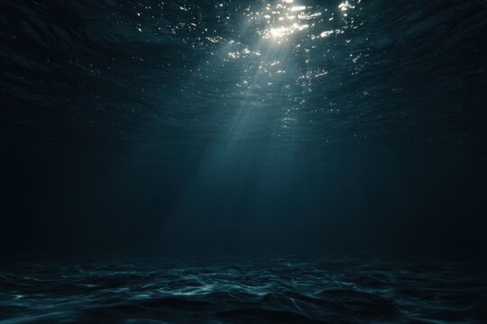 Underwater sunbeams illuminate deep dark water