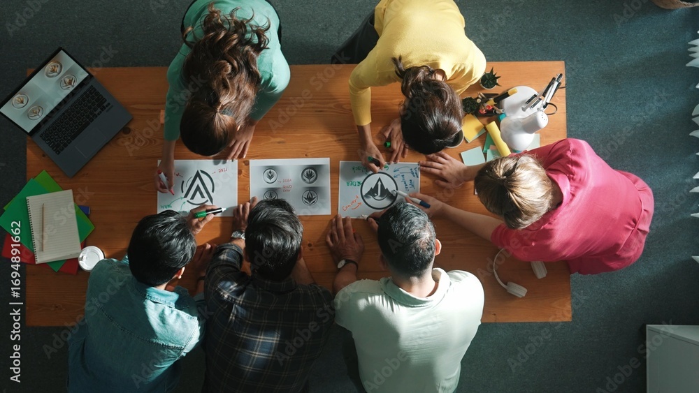 Poster top view of smart business team put graphic logo on meeting table and start to design while explain 