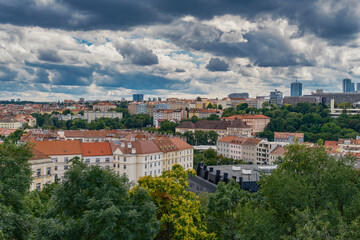 Breathtaking panoramic view of Prague, showcasing its historic city center with iconic buildings, charming red-roofed houses.
