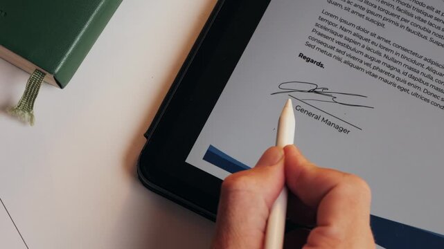Stylus macro on tablet. painting Electronic Signature on Tablet Computer by Stylus in Male Hand. Sign Document of Deal on PC at Work in Office Indoors. Write Business Agreement for