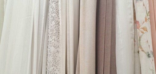 Curtains assortment in the home decor store. New high-quality curtains goods. Fabric store. Interior design. Sale and purchase of curtains and drapes. Curtains assortment. Fabrics of different colors