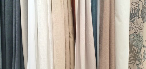 Curtains assortment in the home decor store. New high-quality curtains goods. Fabric store. Interior design. Sale and purchase of curtains and drapes. Curtains assortment. Fabrics of different colors
