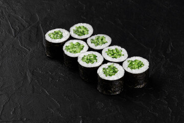 Kappa maki sushi rolls with cucumber filling on black background © nazarovsergey