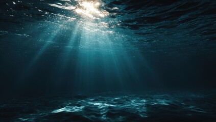 Underwater sunbeams illuminating dark ocean floor