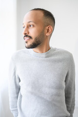 Fototapeta premium young islamic arab man against white studio wall
