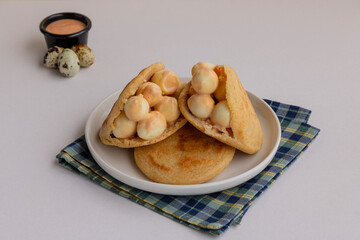 Traditional South American arepa with quail egg, styled as a hearty breakfast option for Latin cuisine food stock