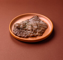 Grilled beef steak, meat cooked on barbecue with salt and pepper. Grilled beef steak