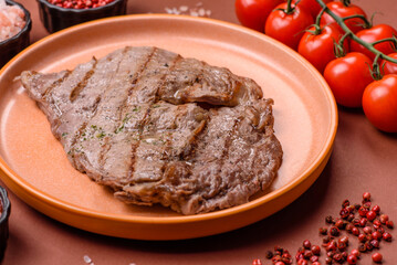 Grilled beef steak, meat cooked on barbecue with salt and pepper. Grilled beef steak